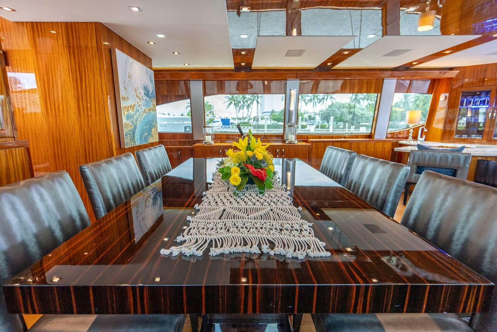 a room with a table and chairs aboard DONE DEAL Yacht for Charter