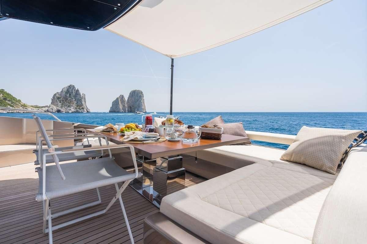 a table and chairs on a beach aboard KAR Yacht for Charter