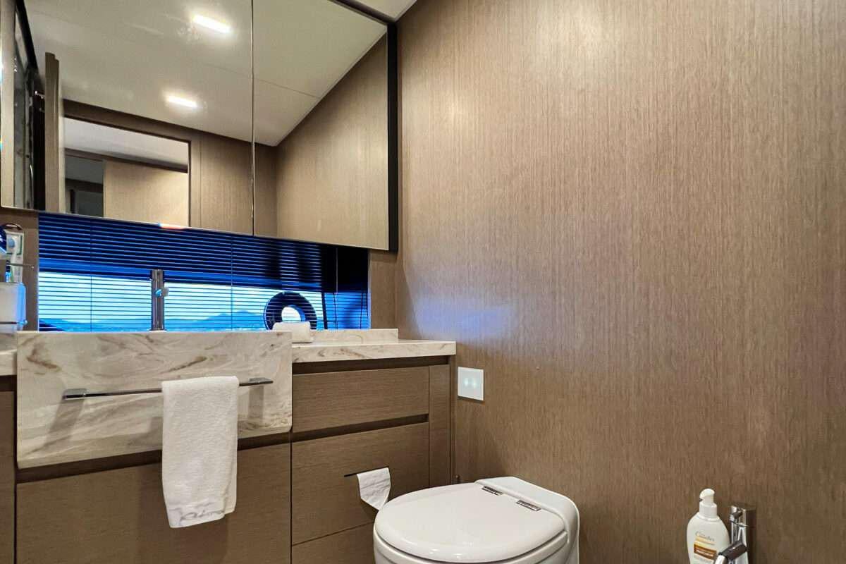 a bathroom with a countertop sink and a mirror aboard KAR Yacht for Charter