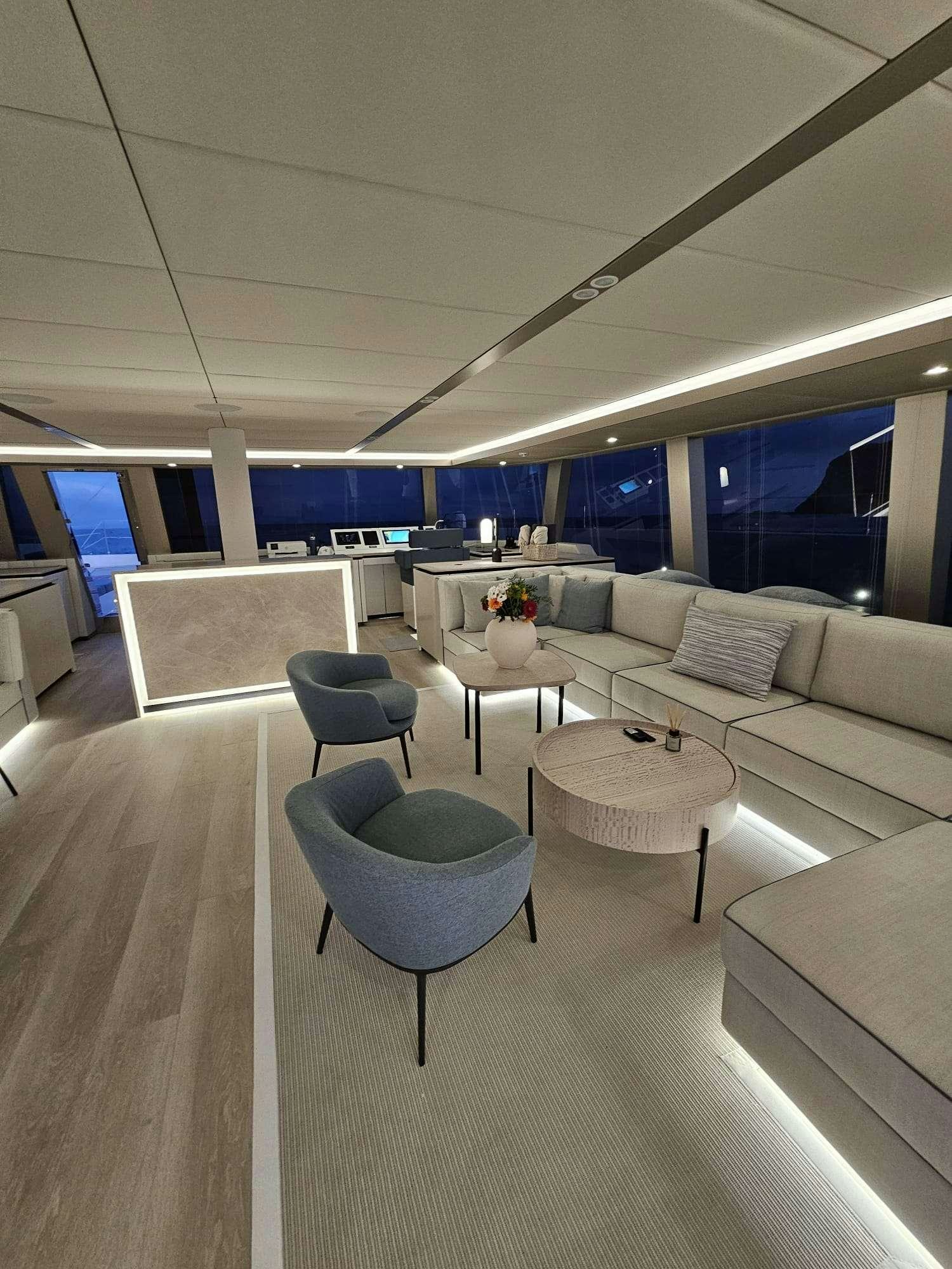 a room with a couch and a table aboard ENTRE4 Yacht for Charter