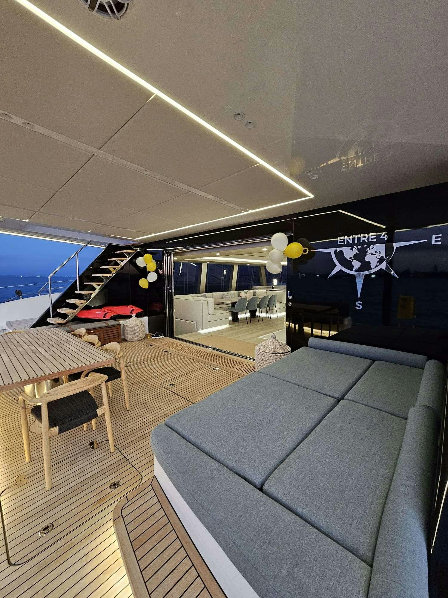 a room with a large bed and a large window aboard ENTRE4 Yacht for Charter