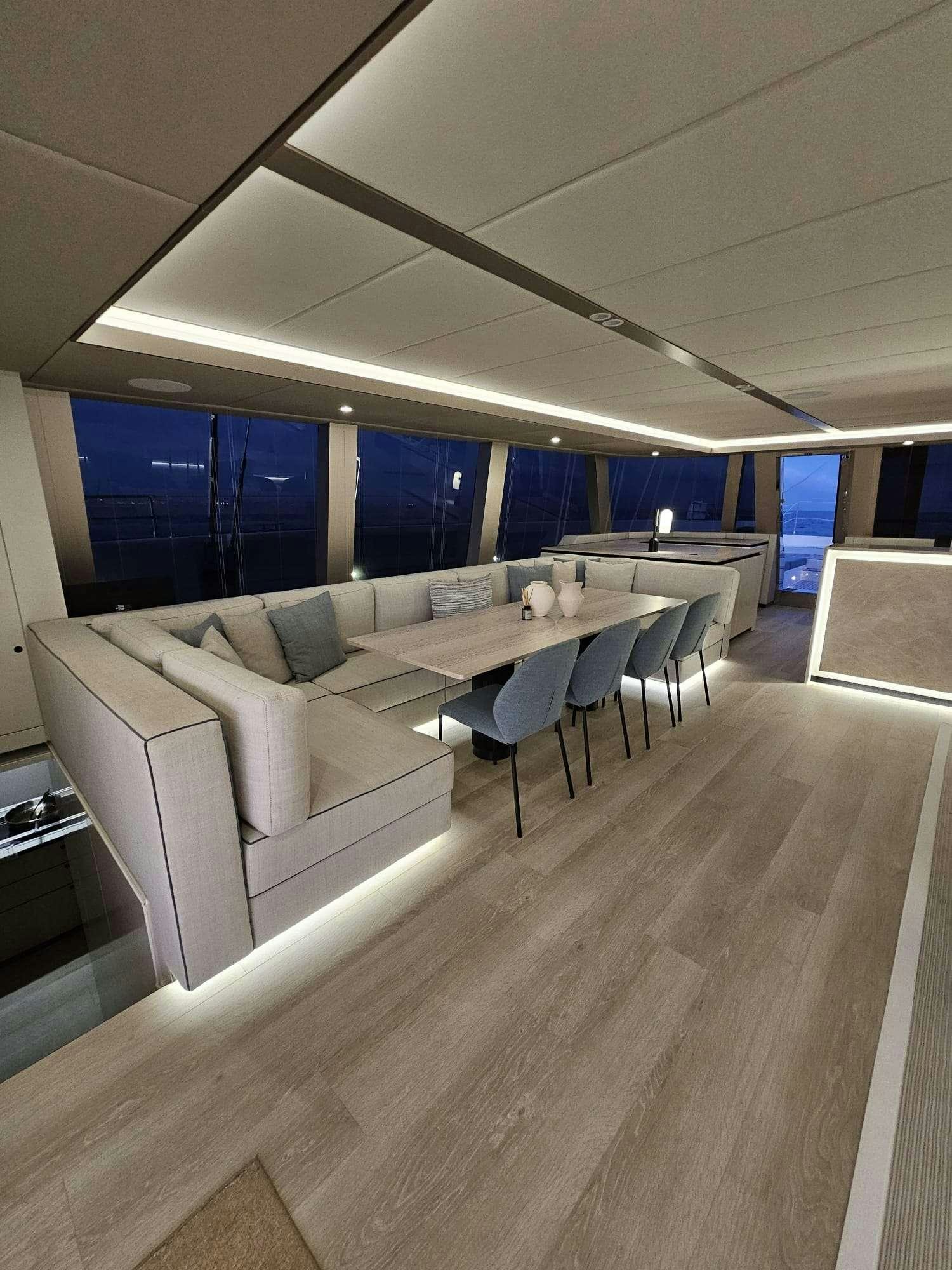 a room with a couch and a table aboard ENTRE4 Yacht for Charter
