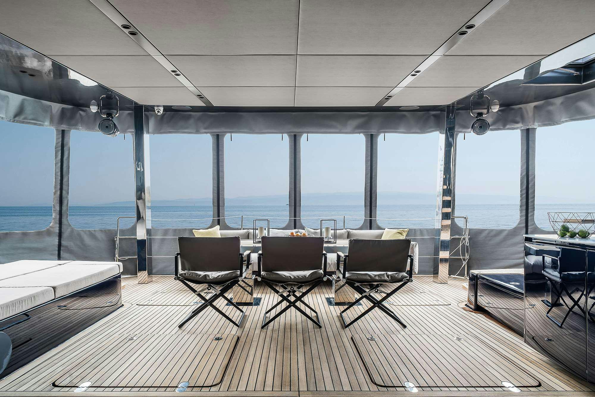 a room with a view of the ocean and a deck aboard ENTRE4 Yacht for Charter
