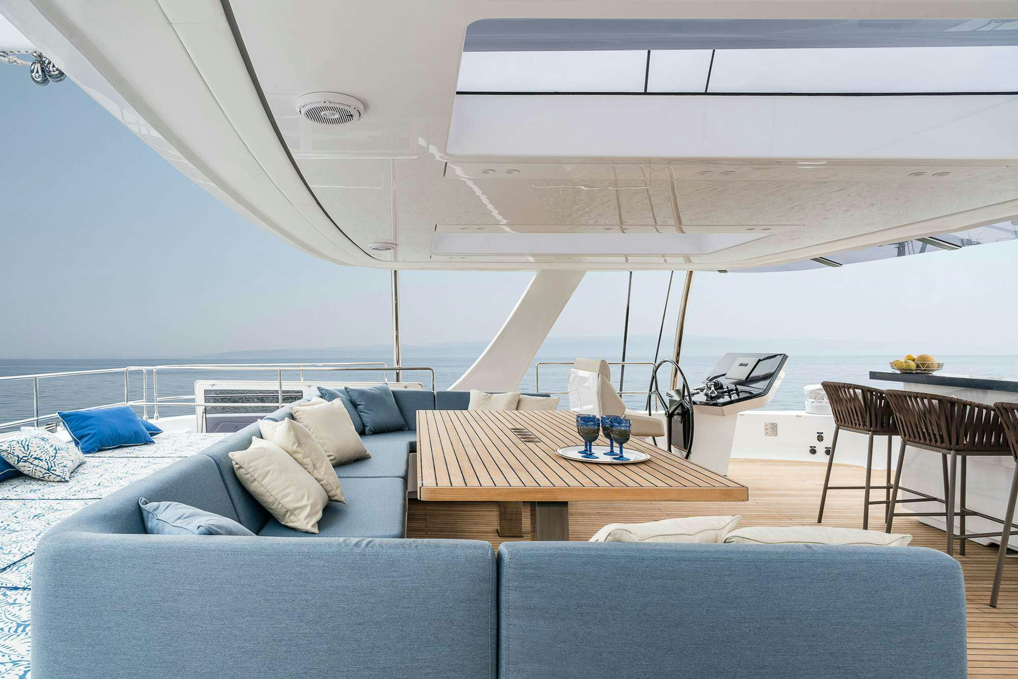 a living room with a couch and a table aboard ENTRE4 Yacht for Charter