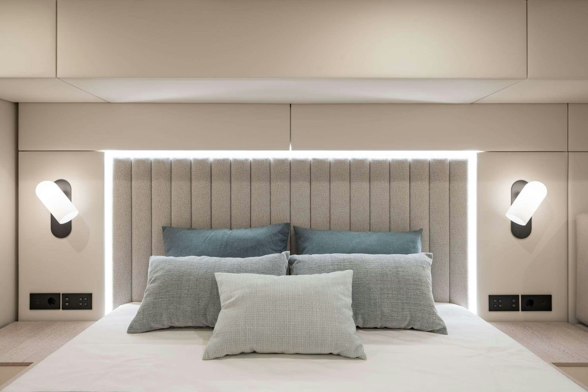 a bed with pillows aboard ENTRE4 Yacht for Charter