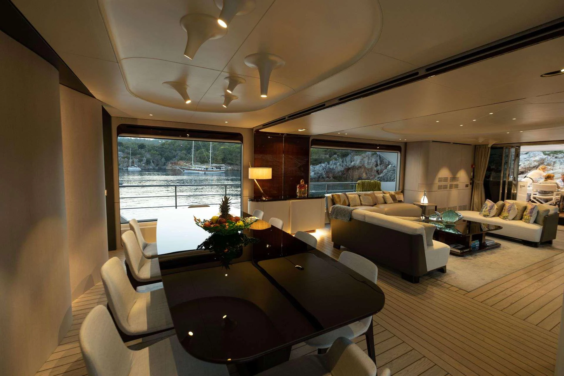 a living room with a table and couches aboard 116 YACHT Yacht for Charter