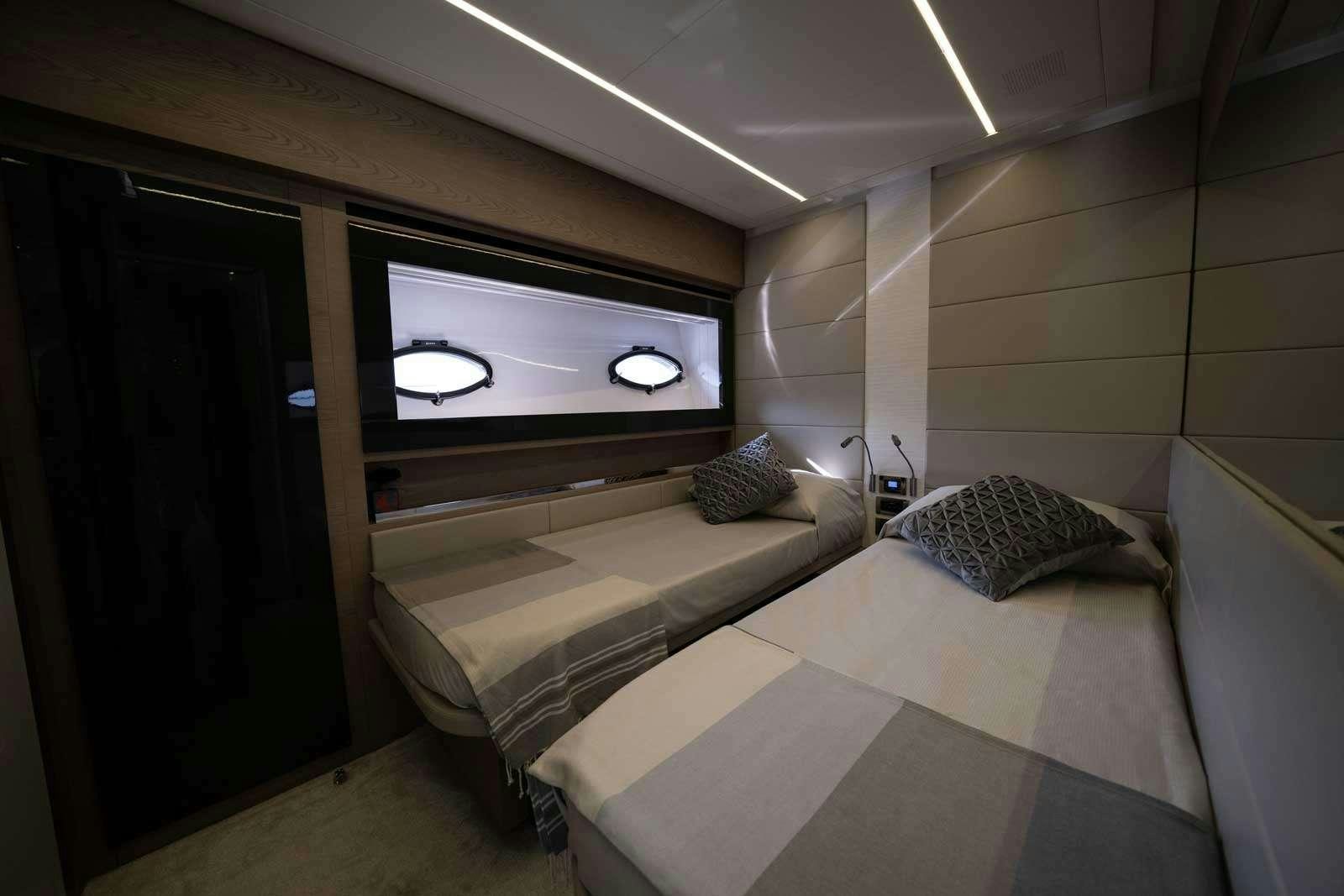 a room with a bed and a tv aboard VELES Yacht for Charter