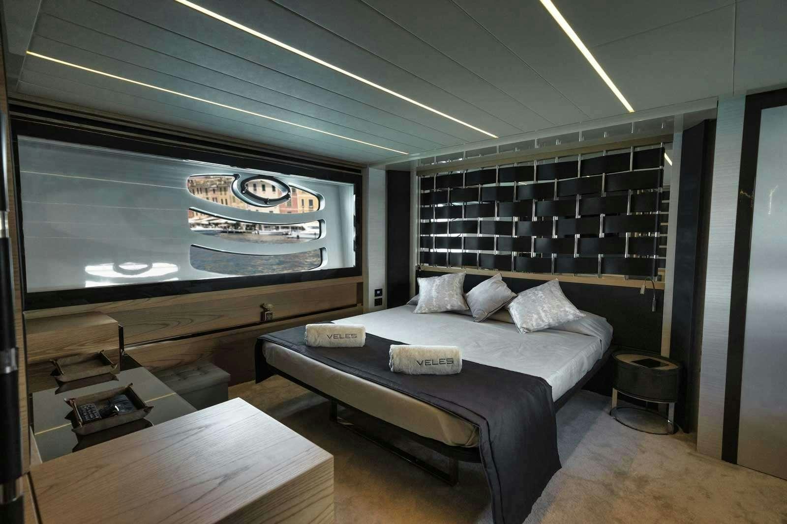 a bedroom with a large tv aboard VELES Yacht for Charter