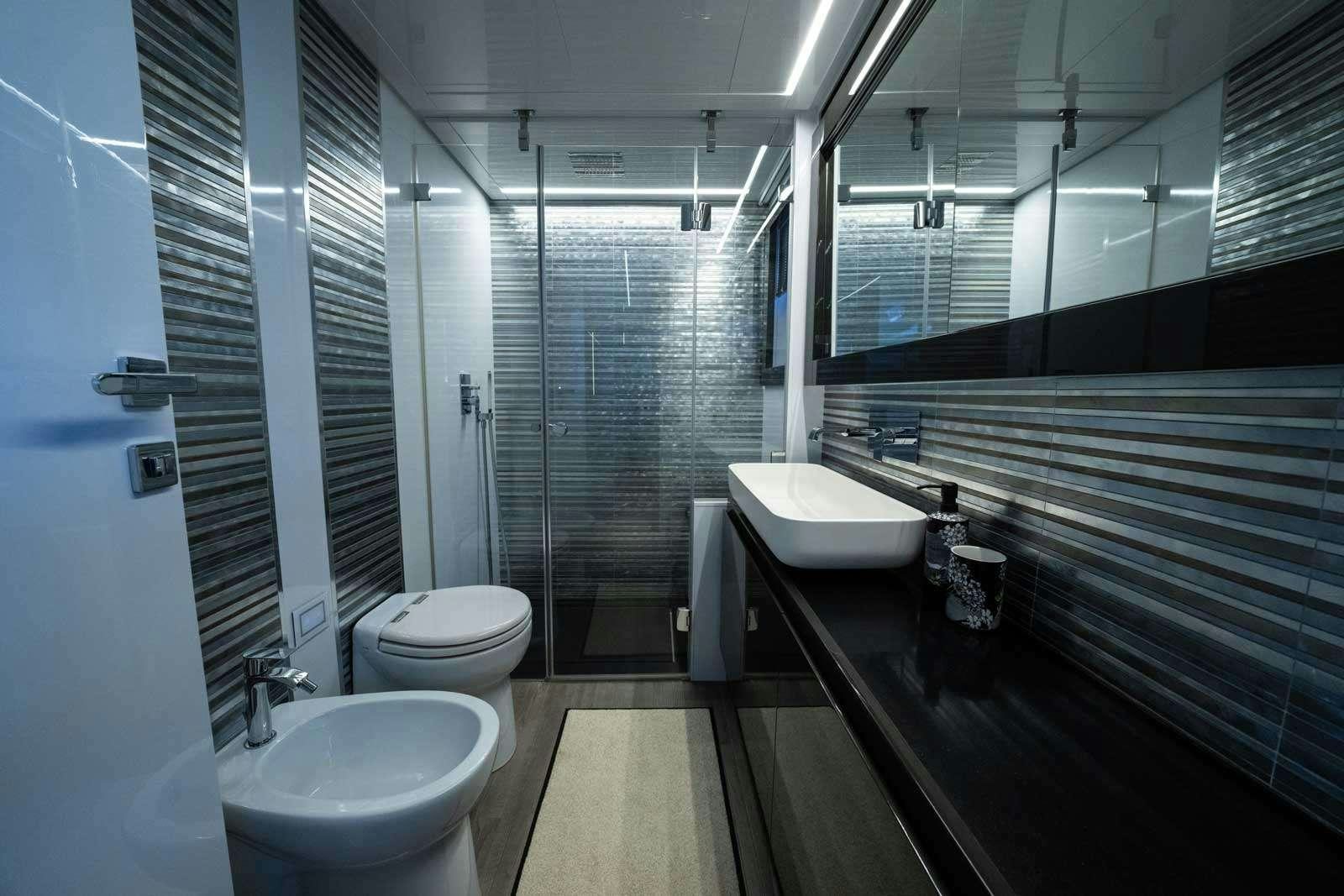 a bathroom with a tub sink and toilet aboard VELES Yacht for Charter