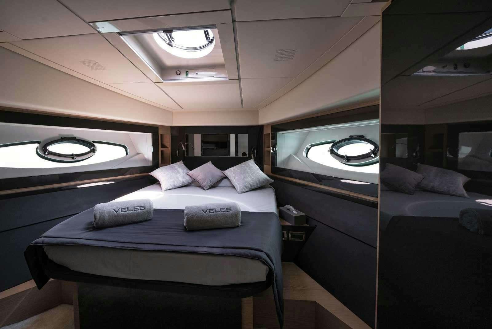 a small bedroom with a bed aboard VELES Yacht for Charter