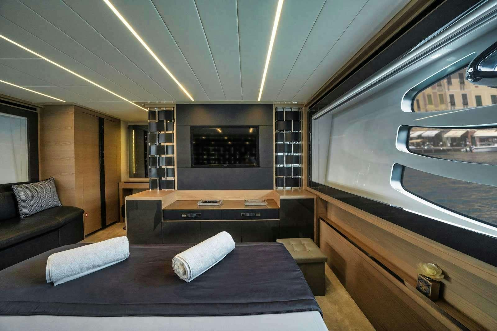 a room with a bed and a couch aboard VELES Yacht for Charter