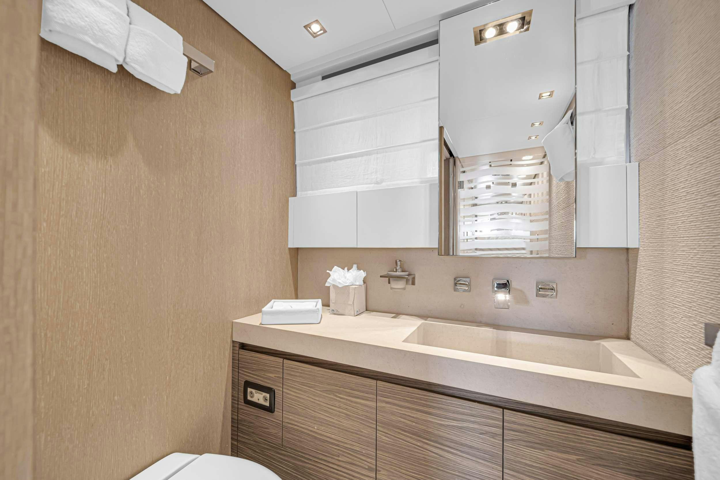 a bathroom with a sink and a mirror aboard ASTONISH Yacht for Charter