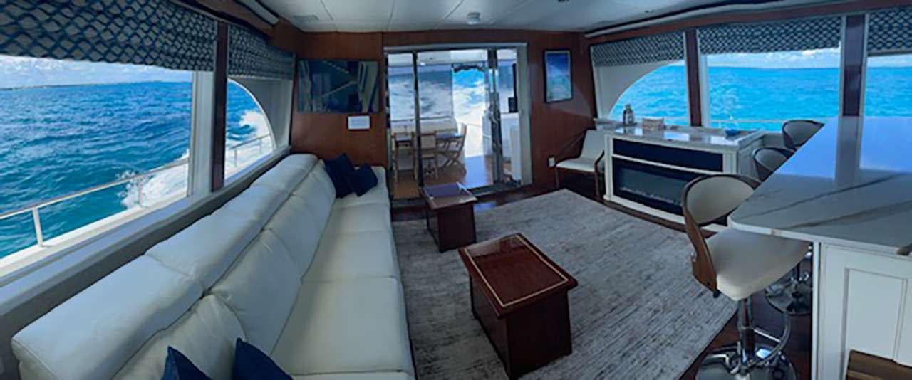 a room with a bed and a table and a window aboard CHASER Yacht for Charter