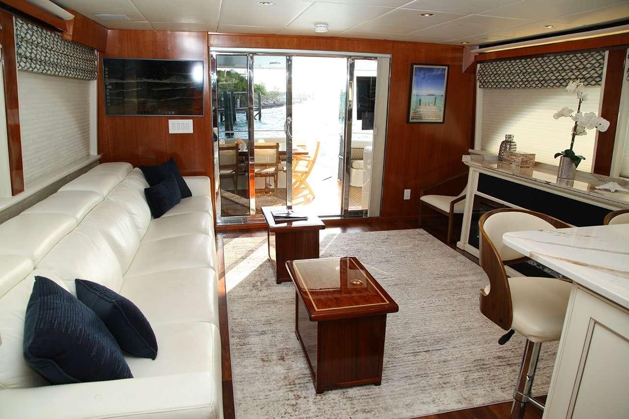 a living room with a couch and a table aboard CHASER Yacht for Charter
