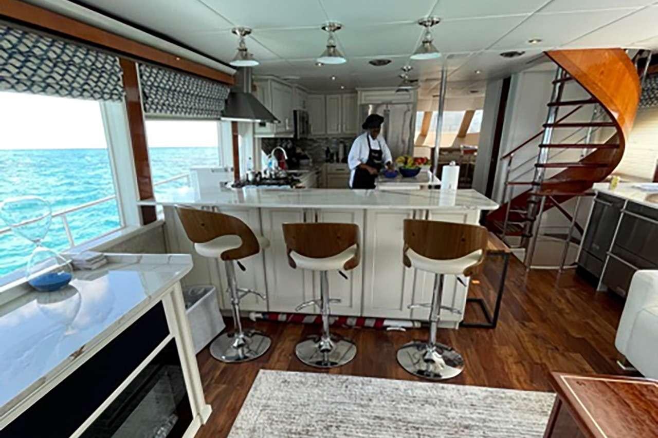 a kitchen with a ladder and chairs aboard CHASER Yacht for Charter