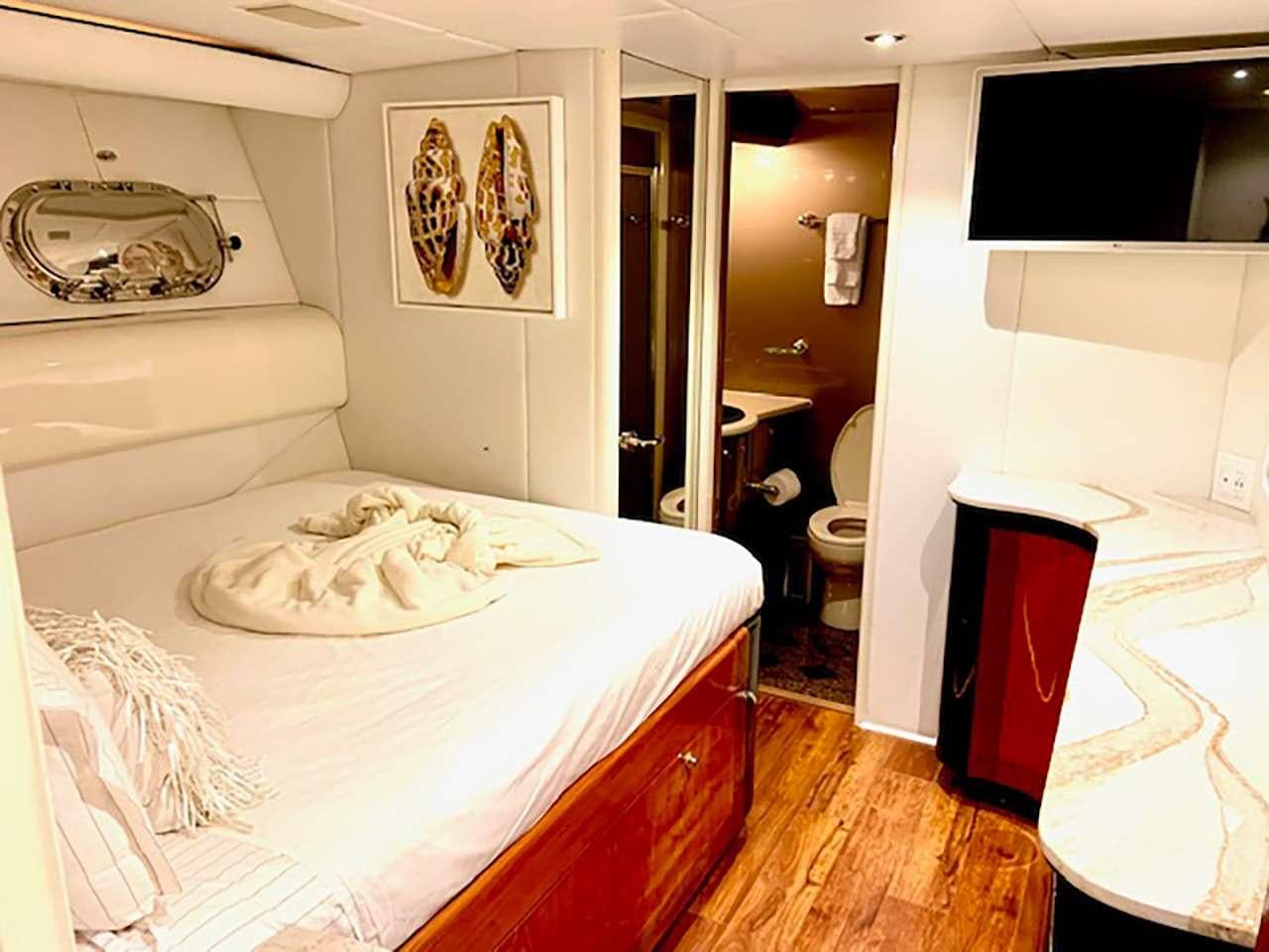a bedroom with a bed aboard CHASER Yacht for Charter