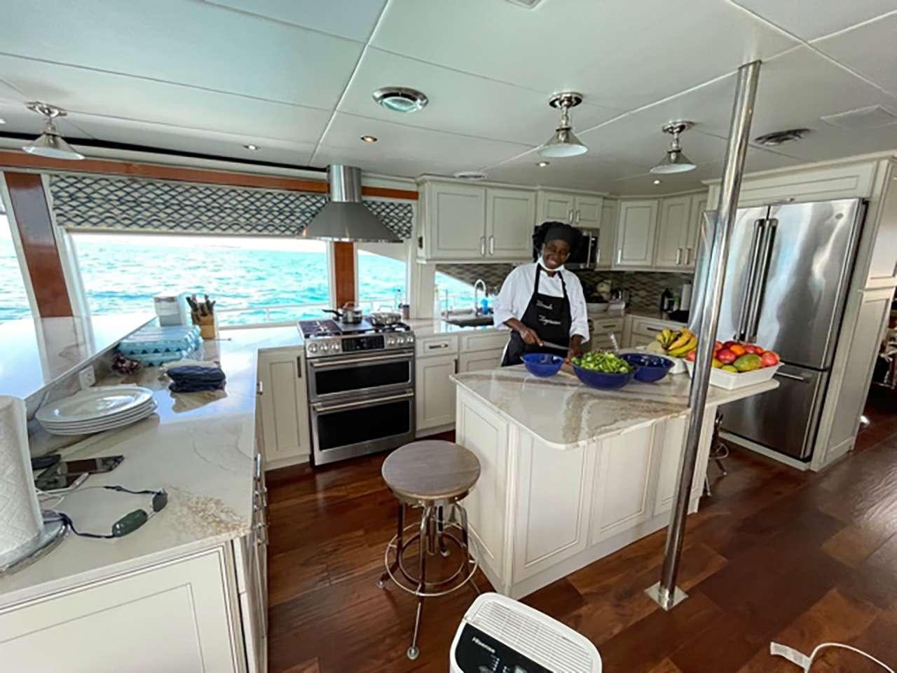 a person in a kitchen aboard CHASER Yacht for Charter