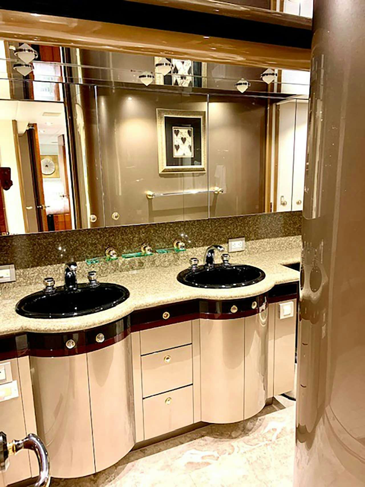a bathroom with a sink and a mirror aboard CHASER Yacht for Charter