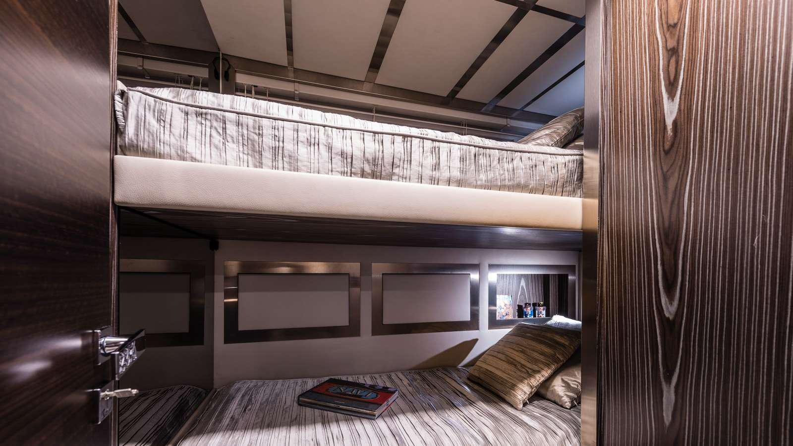 a room with a bed and a table aboard GIGRECA Yacht for Charter