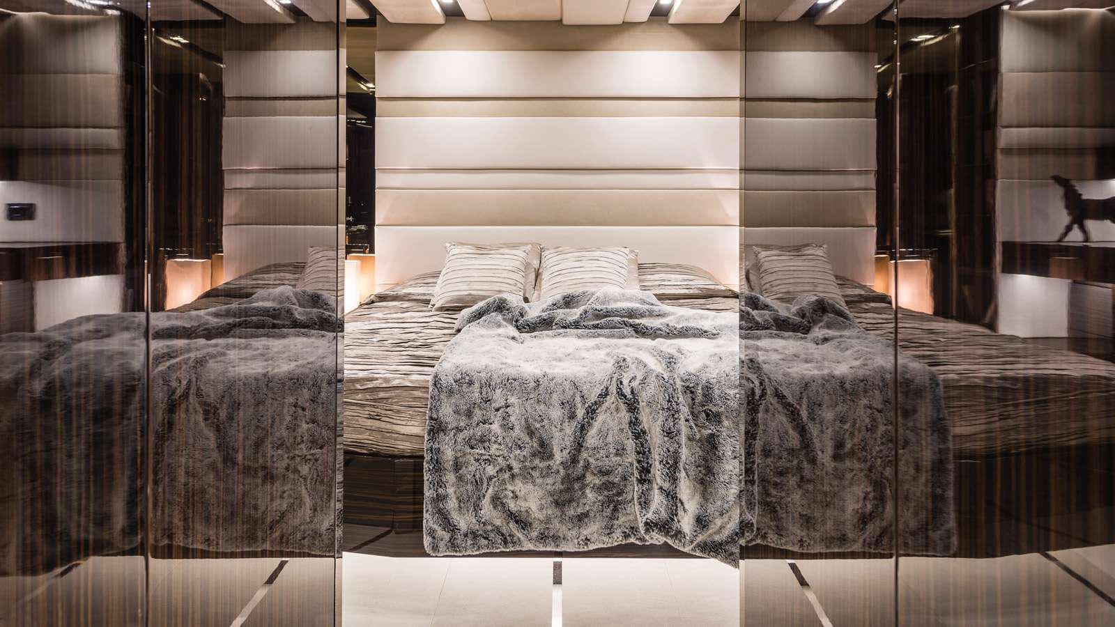 a room with a bed and a table aboard GIGRECA Yacht for Charter