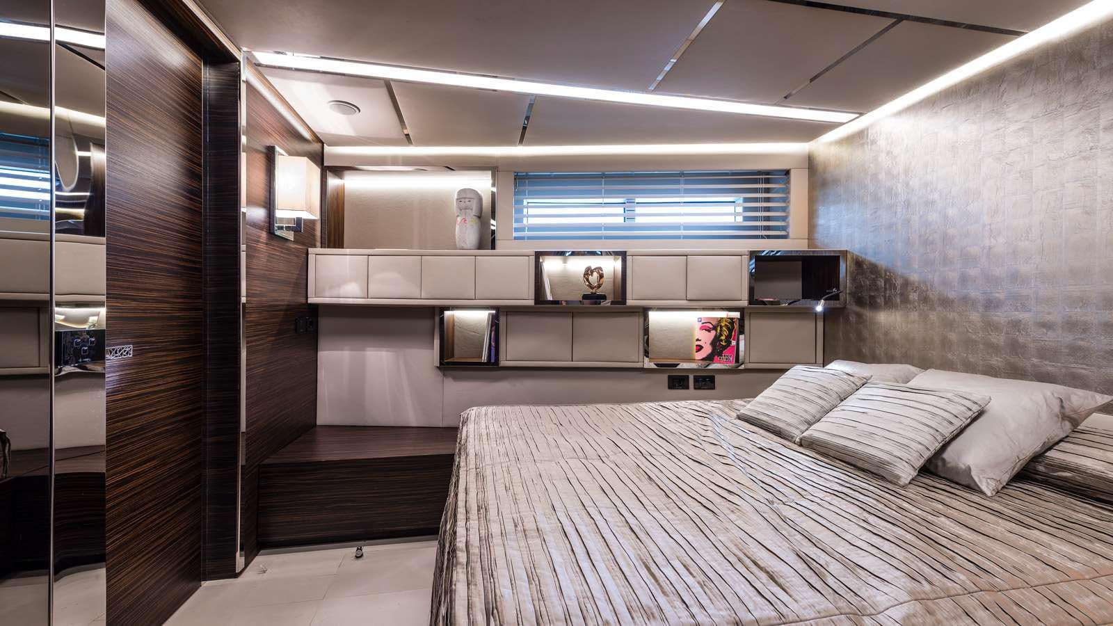 a room with a bed and a tv aboard GIGRECA Yacht for Charter