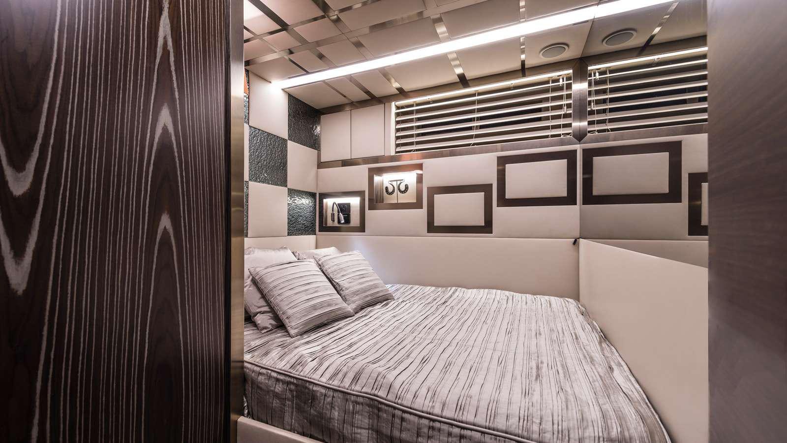 a room with a bed and a curtain aboard GIGRECA Yacht for Charter