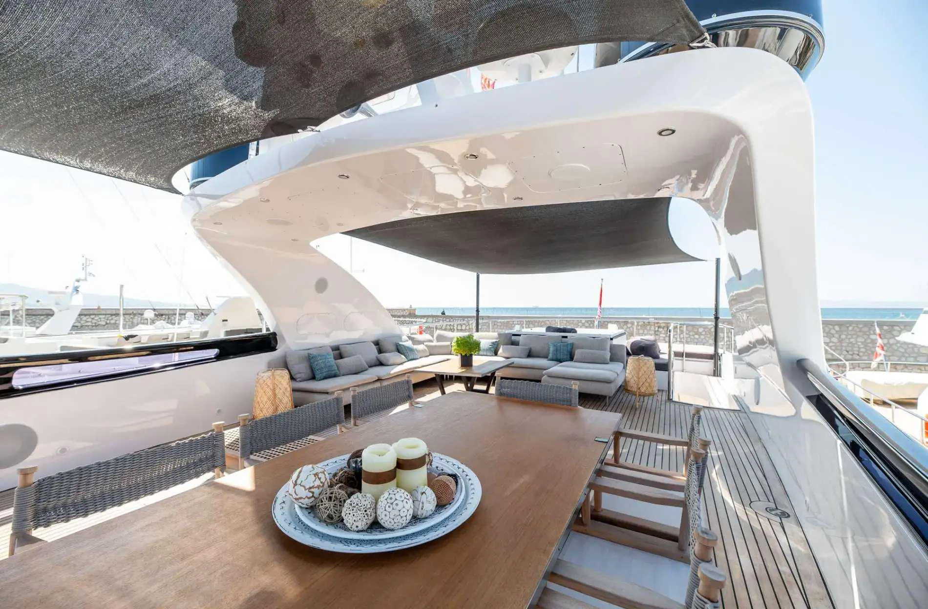 a balcony with a table and chairs aboard PAREAKI II Yacht for Charter