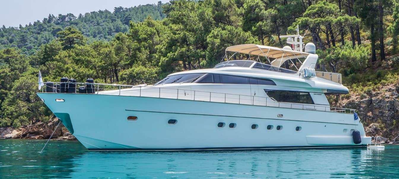 a white boat in a body of water aboard KUUM Yacht for Charter