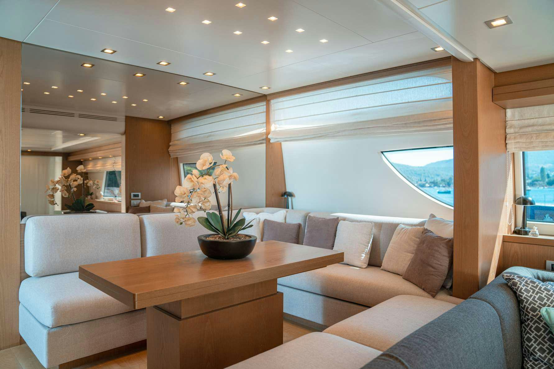 a living room with a table and couches aboard KUUM Yacht for Charter
