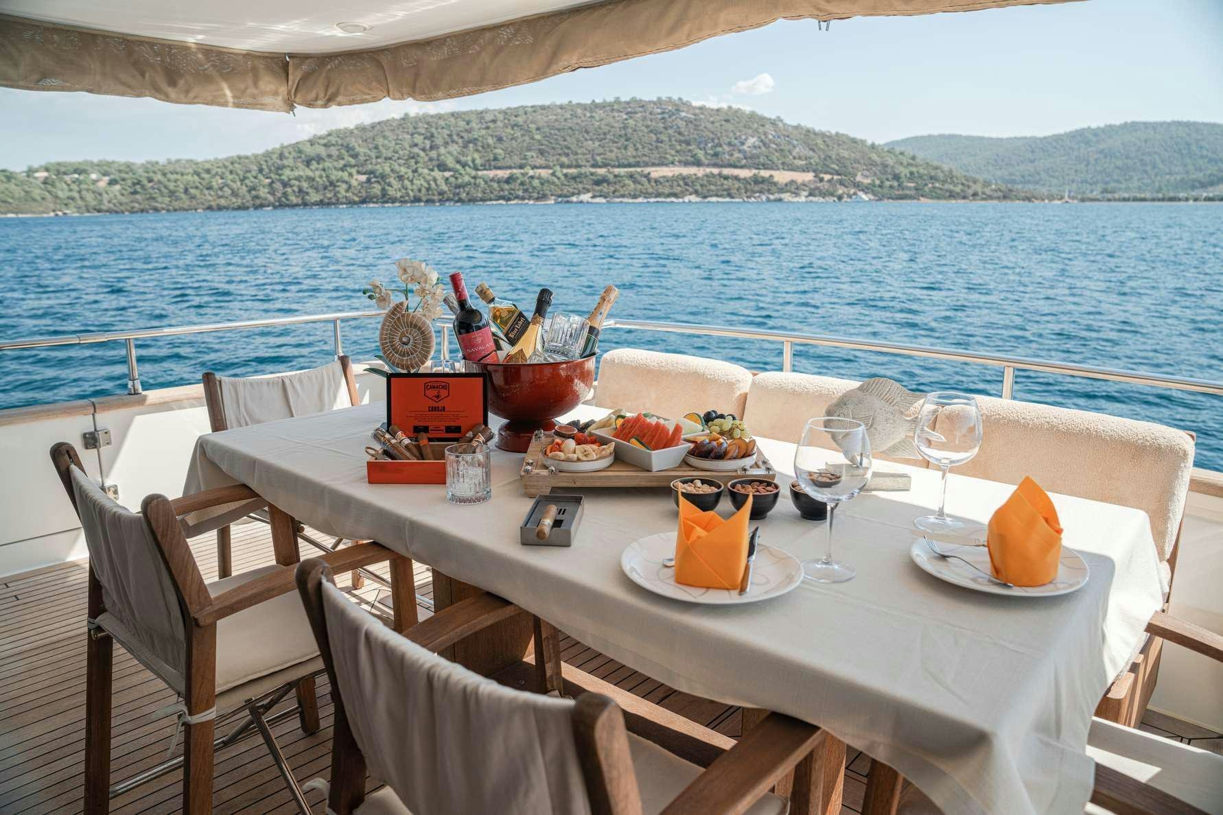 a table with food and drinks on it aboard KUUM Yacht for Charter