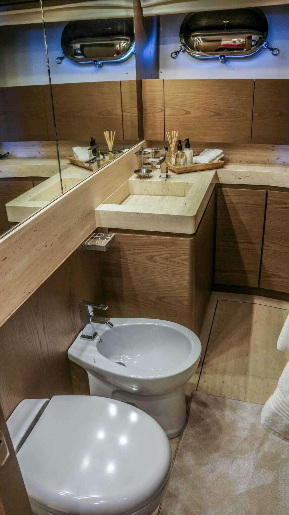 a bathroom with a toilet and sink aboard KUUM Yacht for Charter