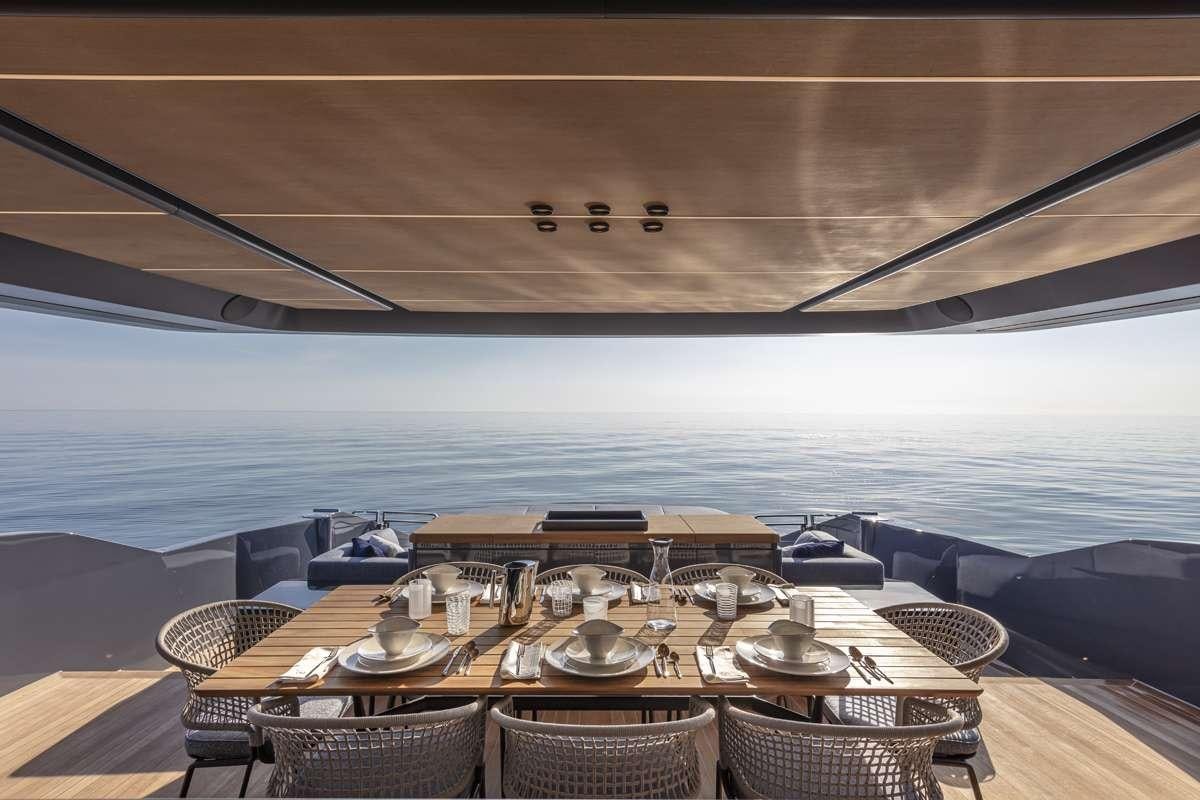 a dining table on a deck overlooking the ocean aboard 86 YACHT Yacht for Charter