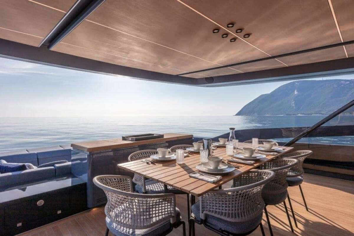 a room with a table and chairs aboard 86 YACHT Yacht for Charter