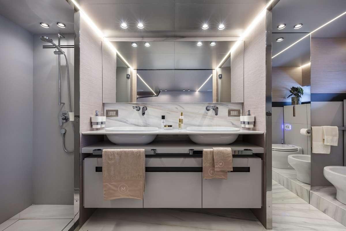 a bathroom with a large mirror aboard 86 YACHT Yacht for Charter