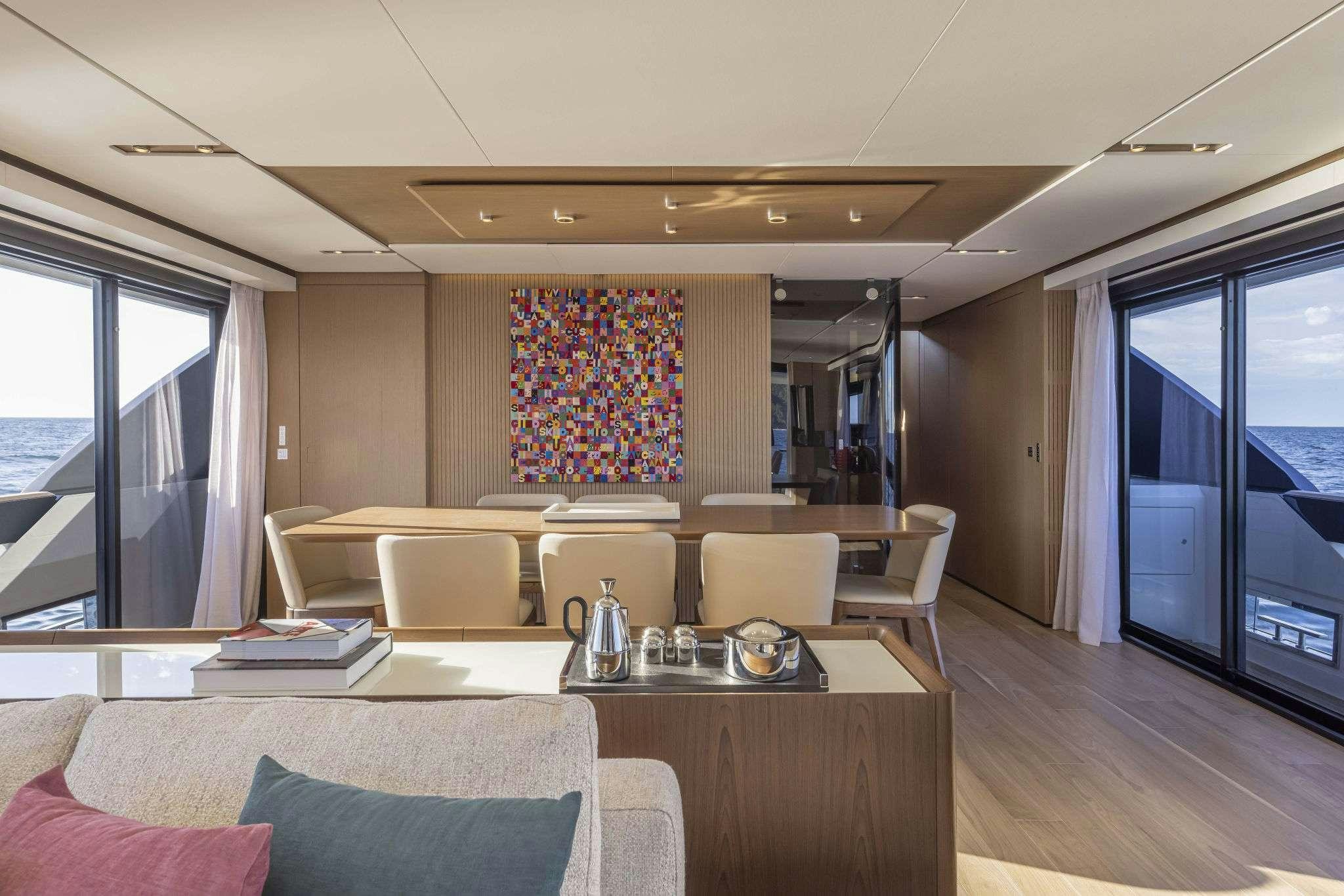 a living room with a large window aboard B.A.13 Yacht for Charter