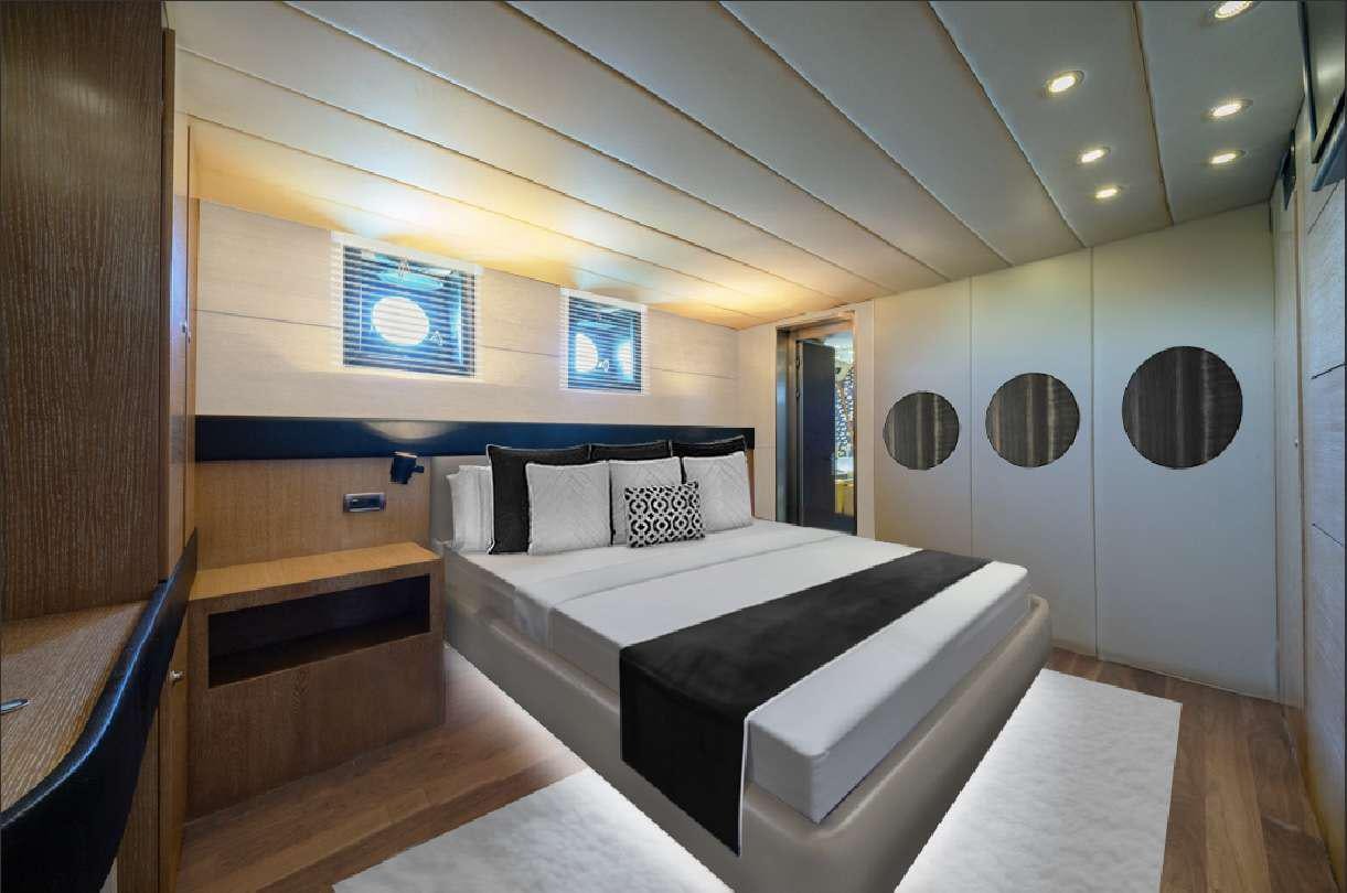 a room with a bed and a mirror aboard GEMAYA Yacht for Charter
