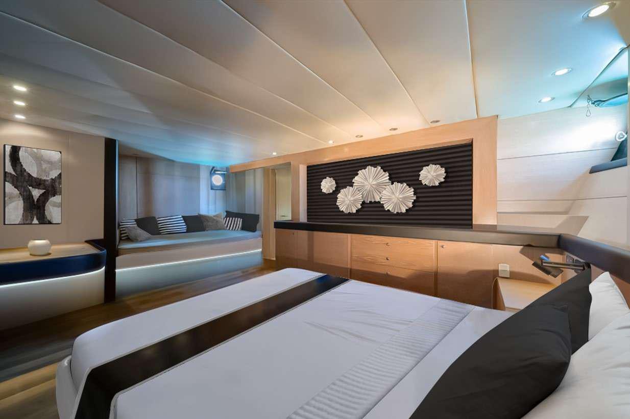 a room with a bed and a desk aboard GEMAYA Yacht for Charter