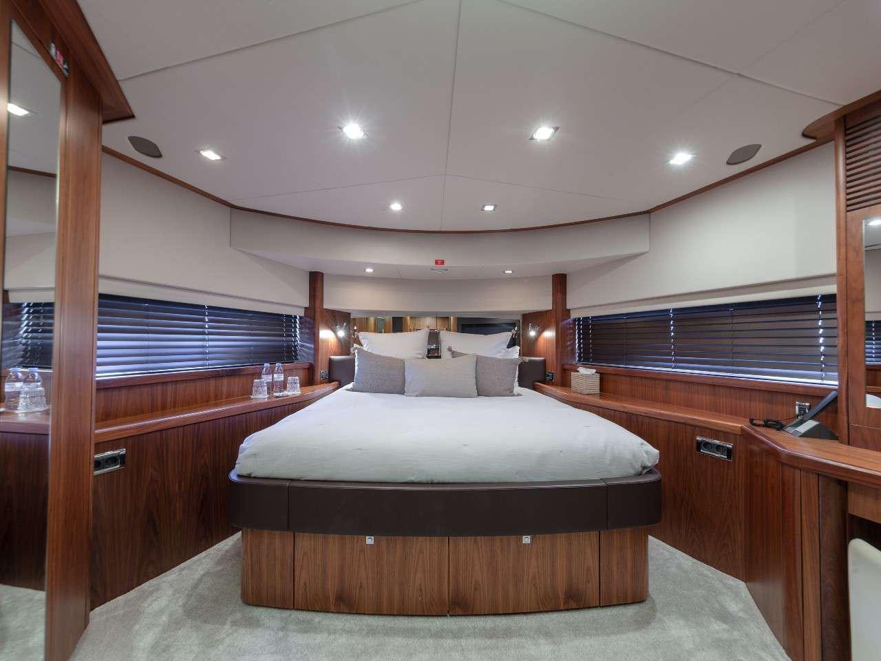 a room with a bed and a wood floor aboard MR SEA Yacht for Charter