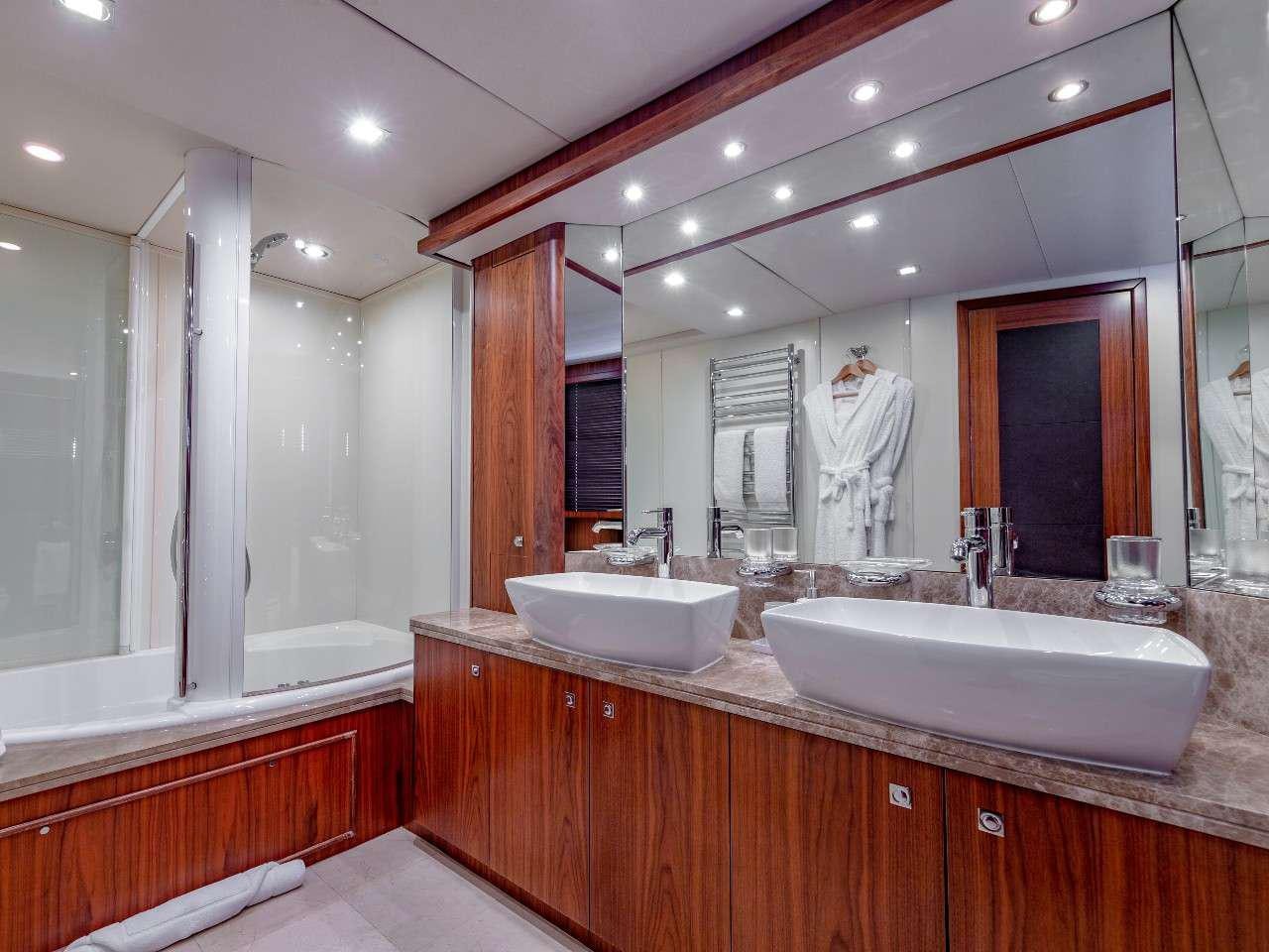 a bathroom with a large mirror aboard MR SEA Yacht for Charter