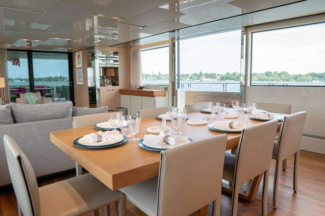 a dining room with a large window aboard GOLDEN YACHT Yacht for Charter