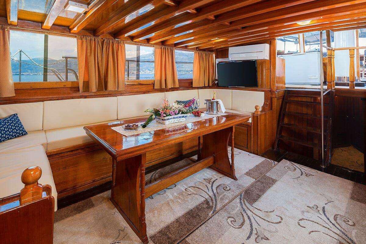 a wooden table in a room aboard GIDEON Yacht for Charter