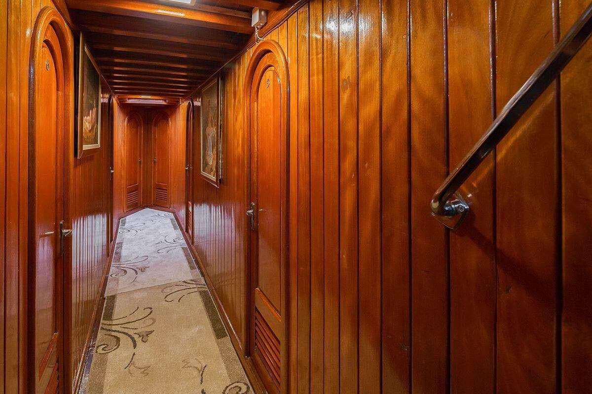 a wooden hallway with wood walls aboard GIDEON Yacht for Charter