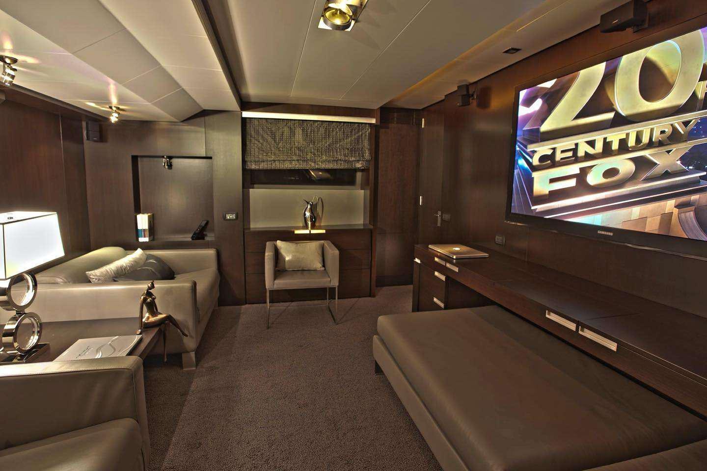 a room with a bed and a television aboard RYLAX Yacht for Charter