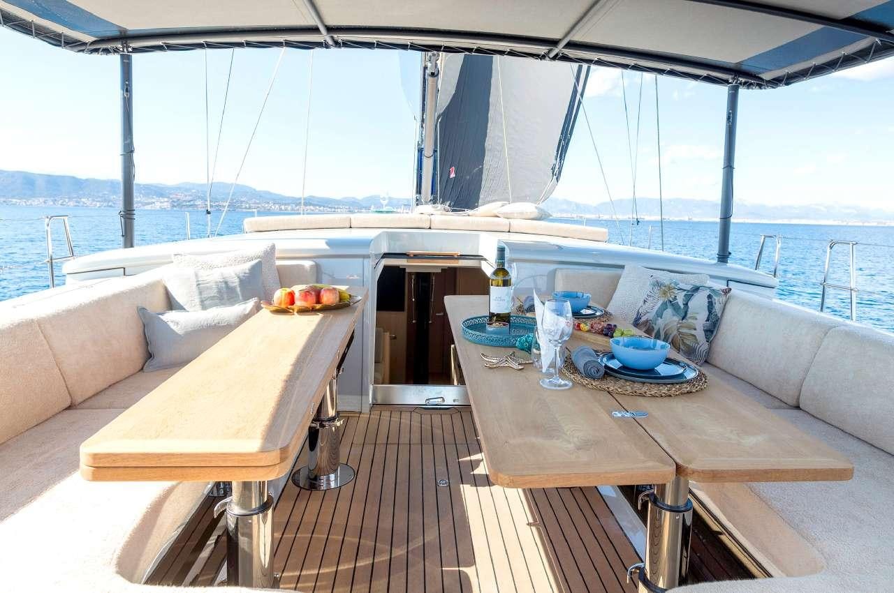 a table on a deck overlooking the ocean aboard YUME Yacht for Charter