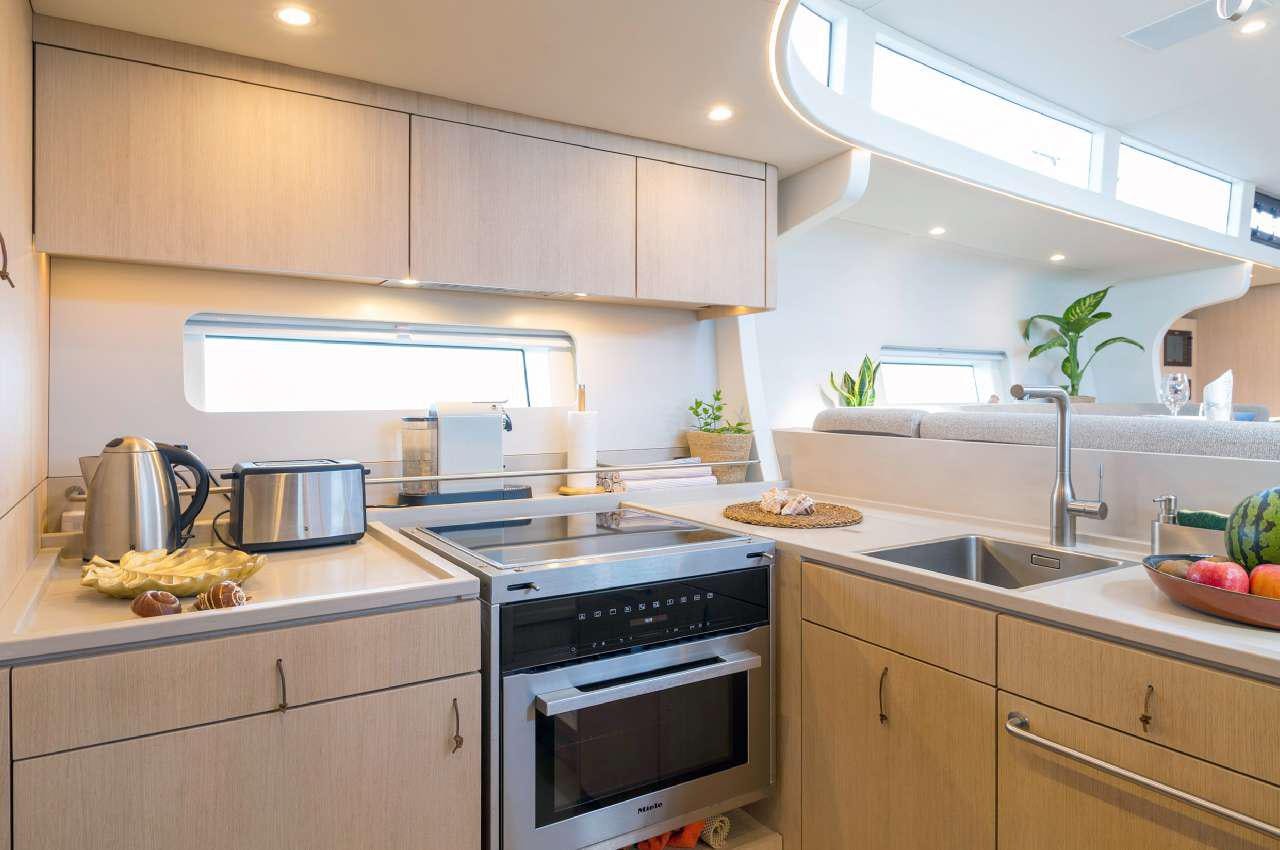 a kitchen with white cabinets aboard YUME Yacht for Charter