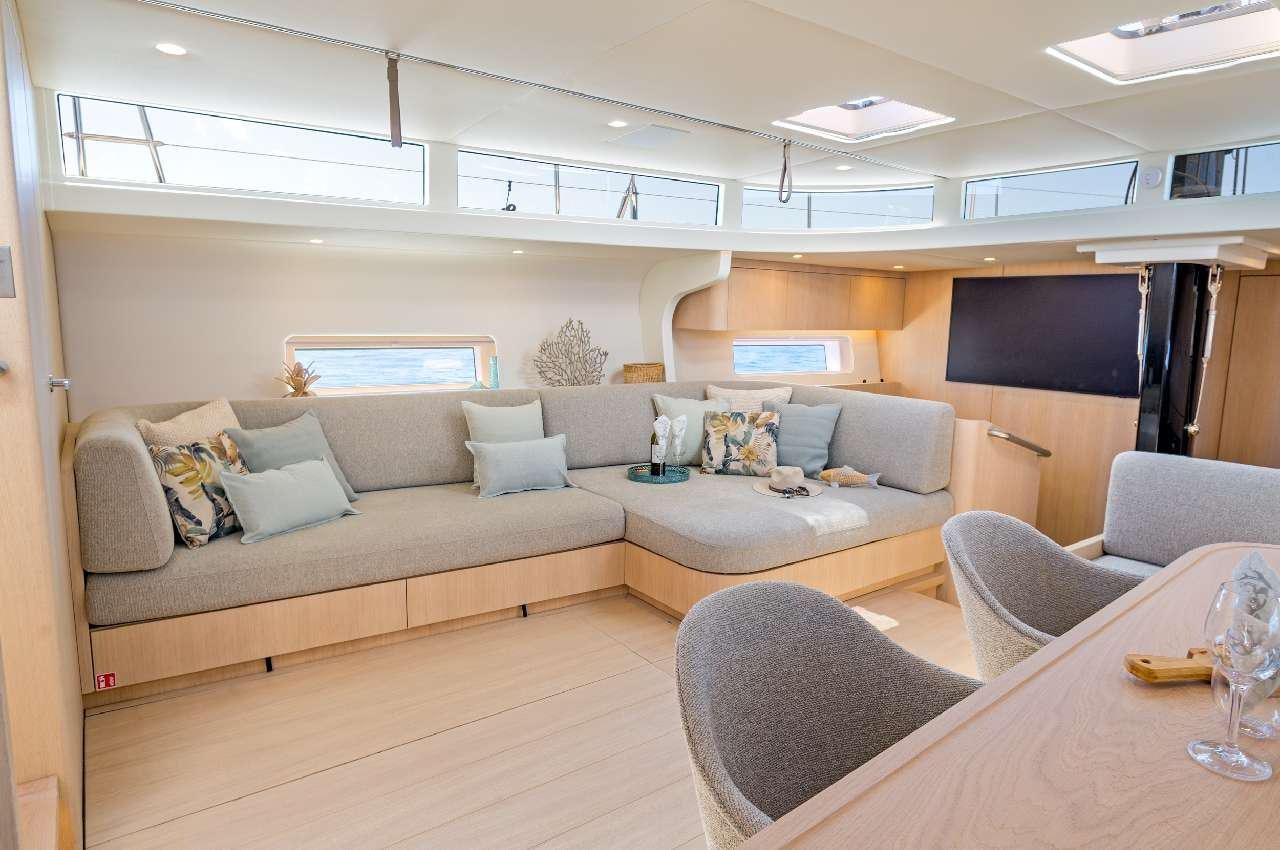 a living room with a couch and a tv aboard YUME Yacht for Charter