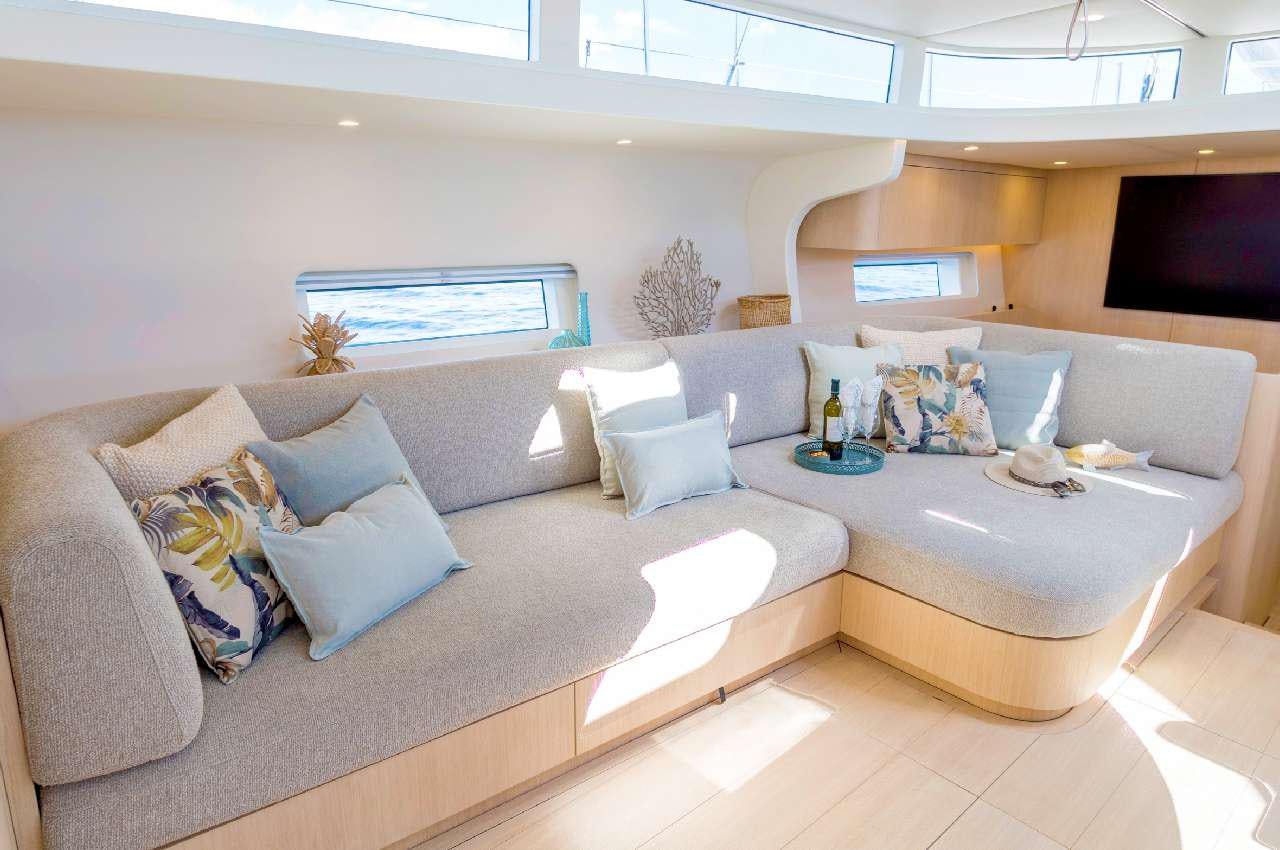 a living room with a couch and a tv aboard YUME Yacht for Charter