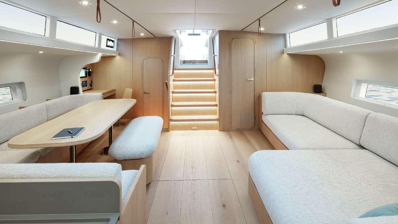 a room with a table and couch aboard YUME Yacht for Charter