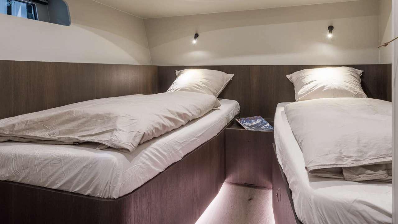 a couple of beds in a room aboard YUME Yacht for Charter