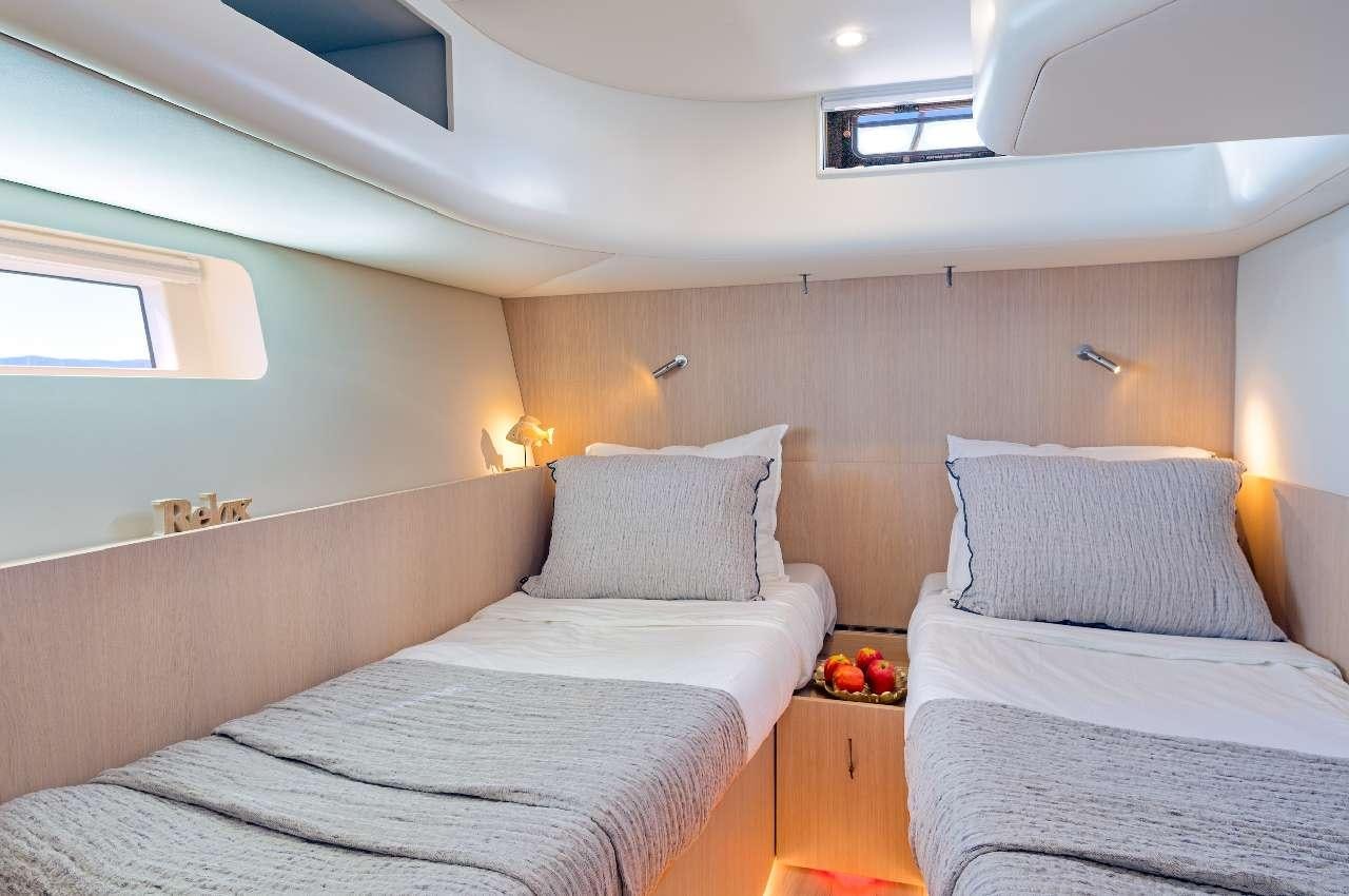 a bedroom with two beds aboard YUME Yacht for Charter
